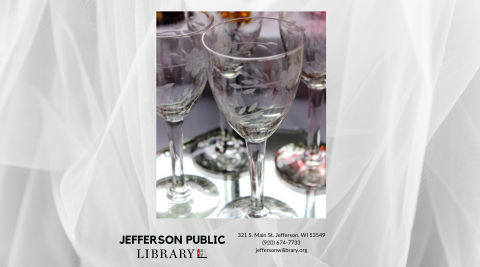 Image of four stemmed glasses with artistic etches in the glass.